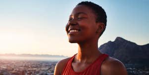 woman smiling outside in the sun