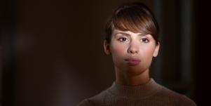 woman in darkness with light on her face