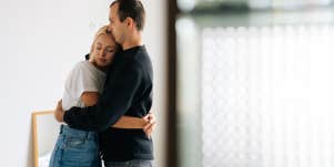 unhappy couple hugging