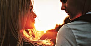 man and woman in shadow of the sunset