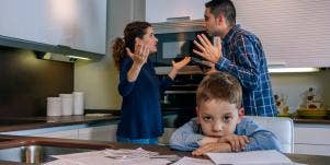 parents arguing behind child