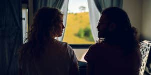 couple looking at each other in dark room