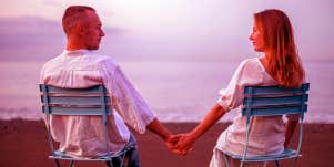 man and woman on the beach holding hands