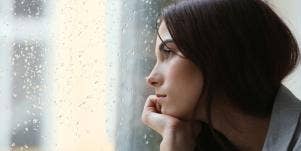 woman staring out the window