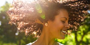 Care-free woman twirls hair