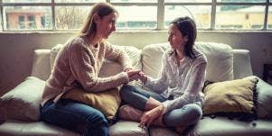 mom talking to daughter on couch