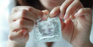 woman opening condom