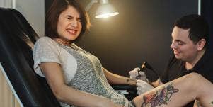 photo of woman getting a tattoo