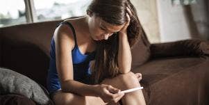 girl holding pregnancy test