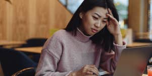 confused woman looking at laptop