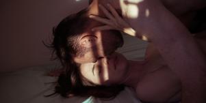 couple in bed kissing