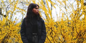 girl standing alone in forest