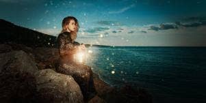 woman by the water at night