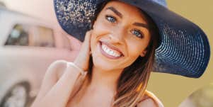 Happy woman in a sunhat 