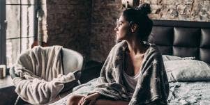 woman alone in bed thinking