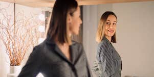 confident woman looking in the mirror