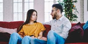 sad man and woman sitting on couch