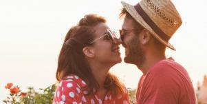 man and woman kissing outside