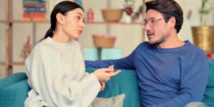 husband and wife talking on the couch