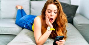 woman shocked looking at phone