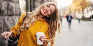 happy woman holding glasses and coffee cup