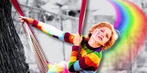 Young boy in rainbow sweater 