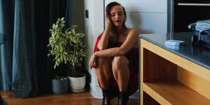 girl kneeling in her apartment 