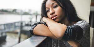 sad woman on window sill
