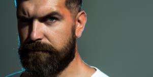 bearded man struggling with toxic masculinity