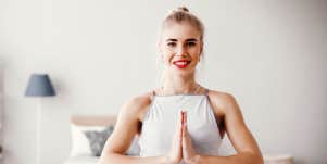 Blonde woman in a yoga pose with a big smile