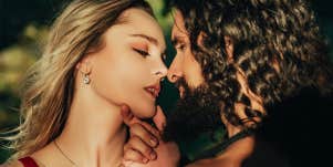 man kissing woman