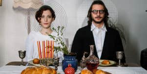 Couple sitting at a dinner table, not speaking staring straight ahead