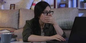 horrified woman at computer