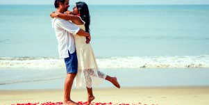 couple hugging on the beach on Propose Day