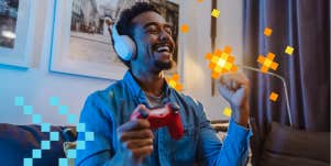 man playing video games and happy