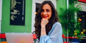 woman sitting at cafe with laptop