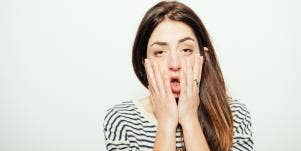 tired woman touching her face