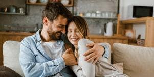 man and woman hugging on couch