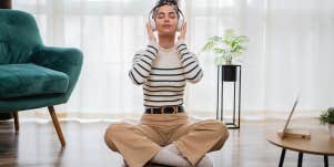 woman sitting alone listening to headphones