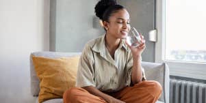 woman drinking water to calm anxiety
