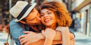 man kissing woman on the cheek