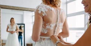 Woman getting wedding dress fitted
