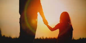 father holding daughter's hand