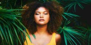 strong woman surrounded by palm trees
