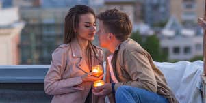 man and woman on romantic rooftop date