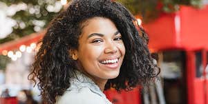 Exuberant woman in the city smiles