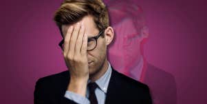 man who is covering his face