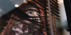 lonely woman looking out window