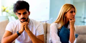 couple sitting on couch wondering what is killing their relationship