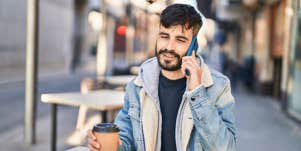 man on phone drinking coffee